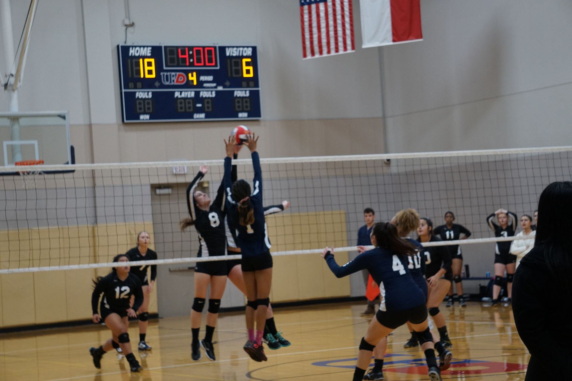 Photo of students from two different teams playing volleyball