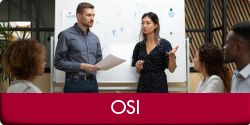 OSI (Photo of two people standing in front of a dry erase board and presenting to a group. "OSI" appears in a red bar along the bottom of the image.)