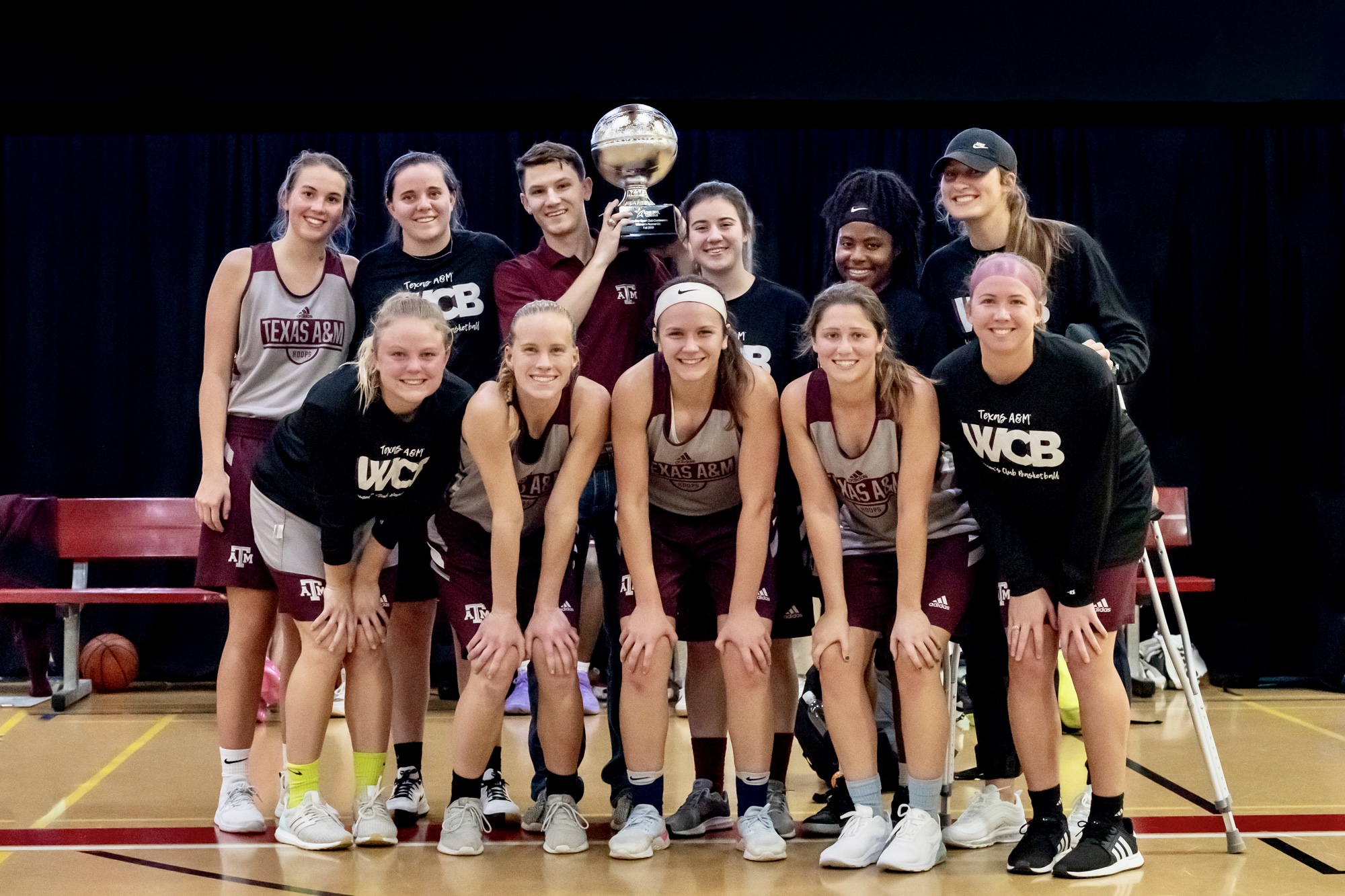 Team photo of students from Texas A&M University with a trophy