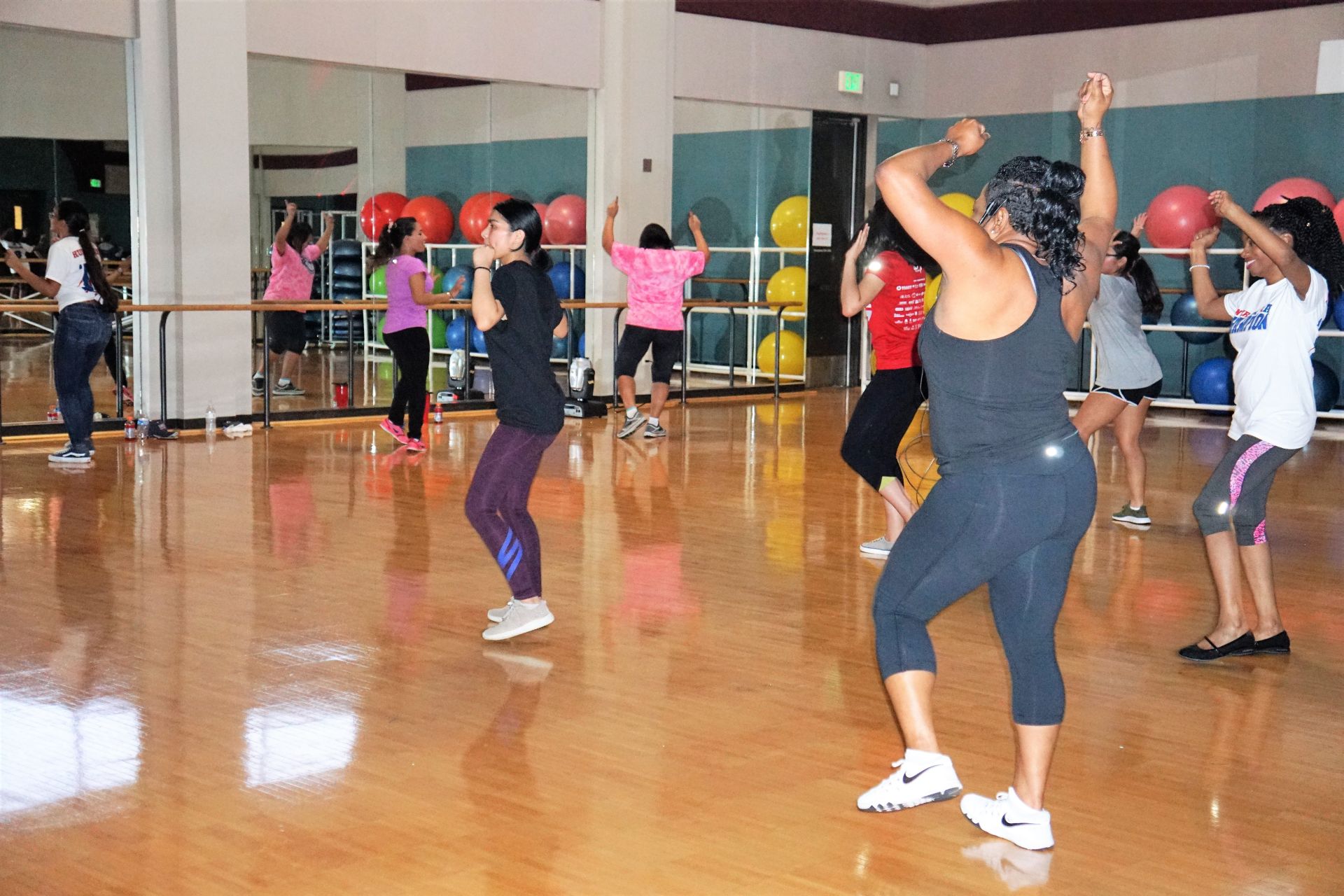 Photo of instructor and students at a zumba event dancing