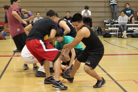 Photo of students playing dodgeball and students in the background watching