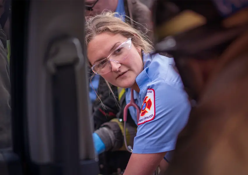 A woman EMS responder working with a firefighter