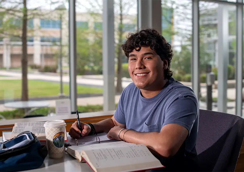 Smiling student studying at a desk
