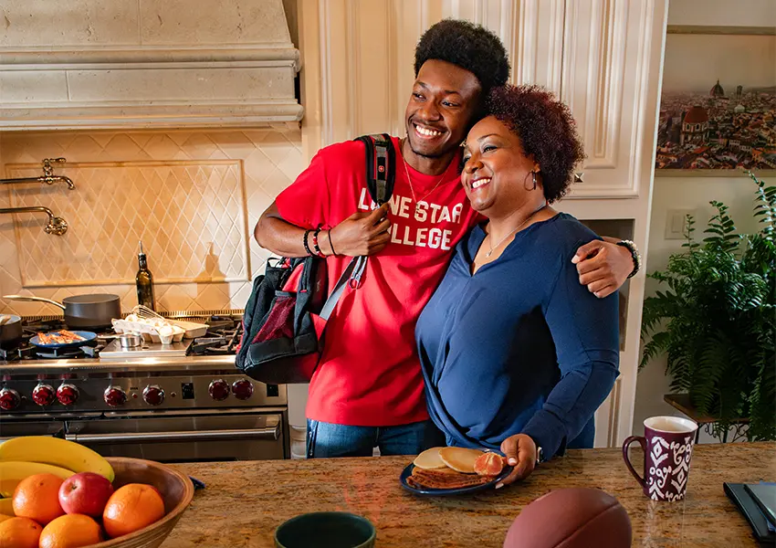 A student and parent in a kitchen