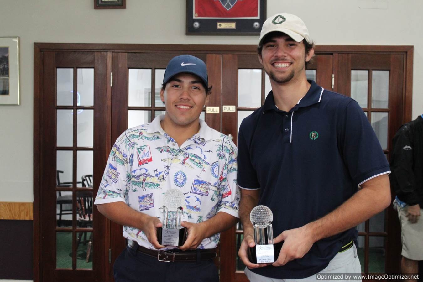 Photo of students posing for photo with trophies