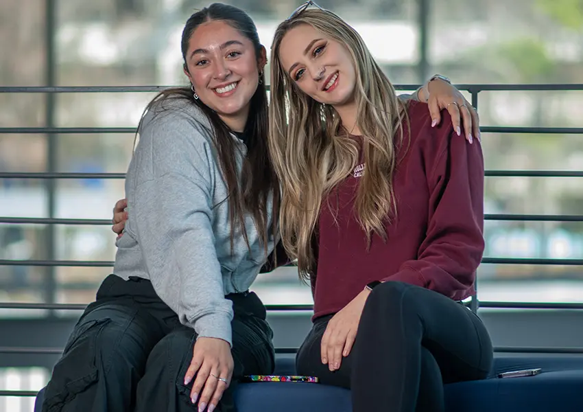 Two Lone Star College Students hugging.