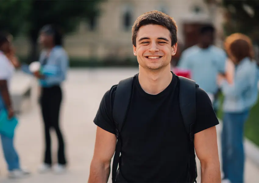 Smiling student wearing a backpack