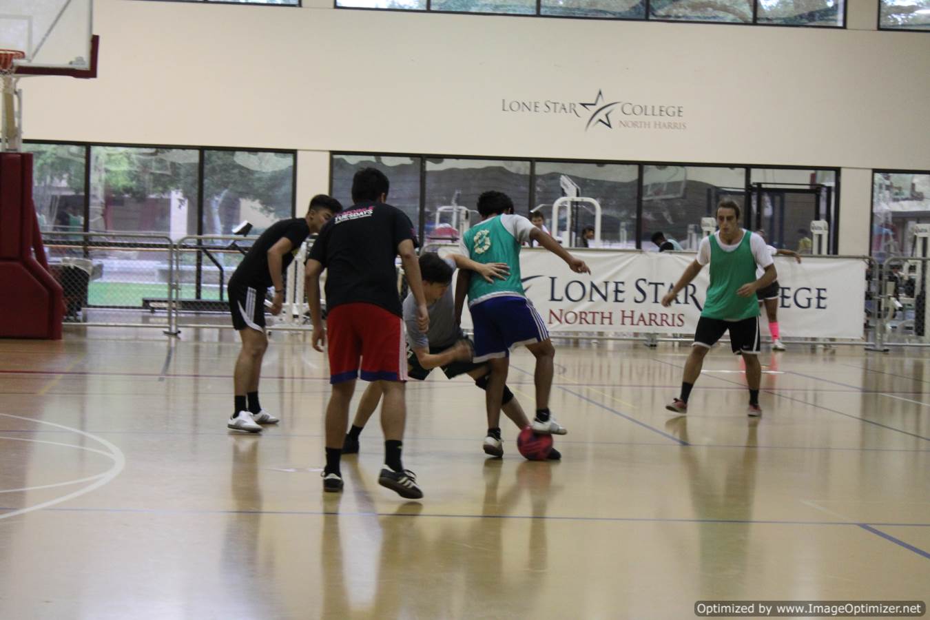 Photo of two different teams playing indoor soccer