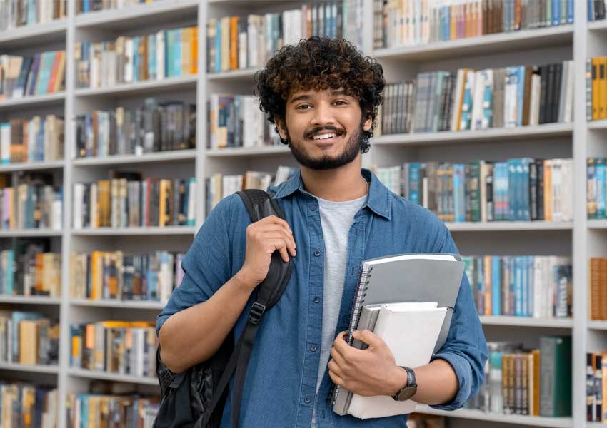 student standing in library