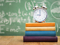 Photo of a clock on top of books