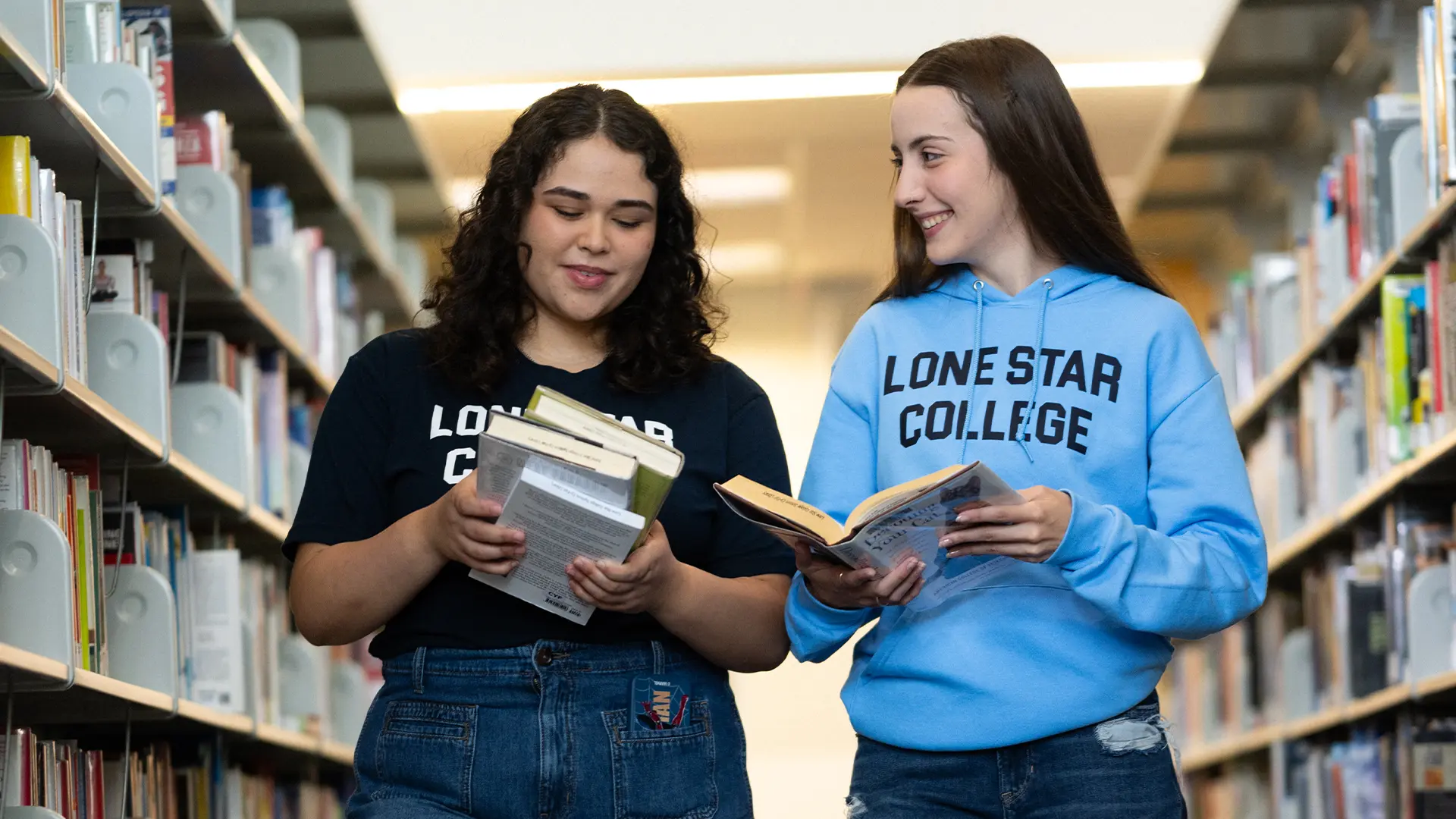 Two students holding books