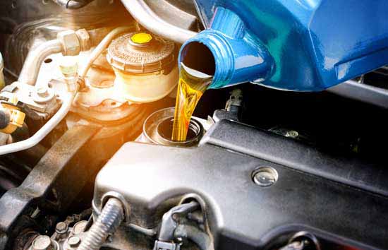 Oil being poured into a car engine