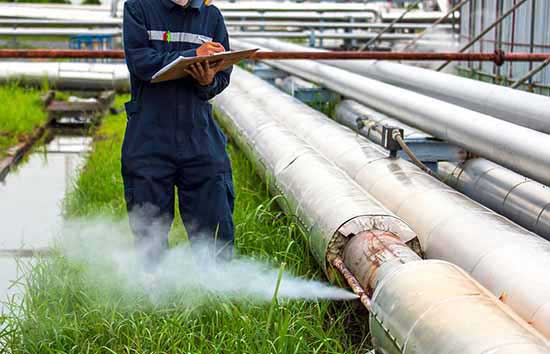 An inspector checking pipes