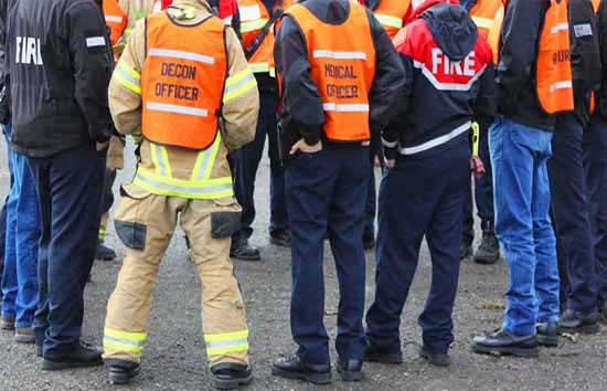 Various emergency personnel standing in a group