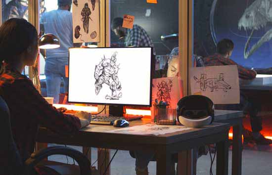 Artist looking at their work on a computer screen