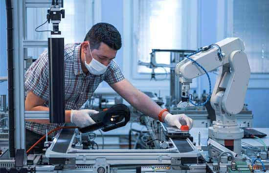 Man inspecting a robot arm