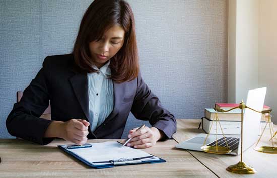 Woman taking notes on a clipboard