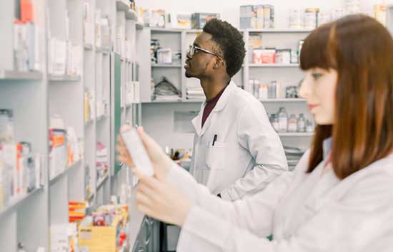 Pharmacists inspecting their stock