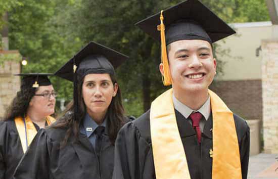 Students standing in a row in their cap and gown