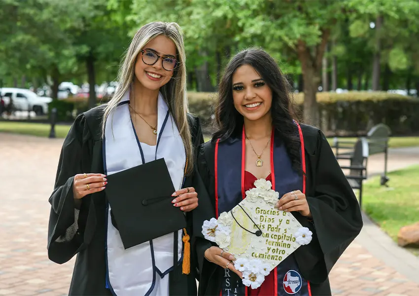 Graduates wearing a grad cap and gown