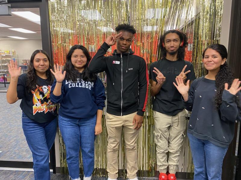 The Student Resource Center Student workers waving at the camera
