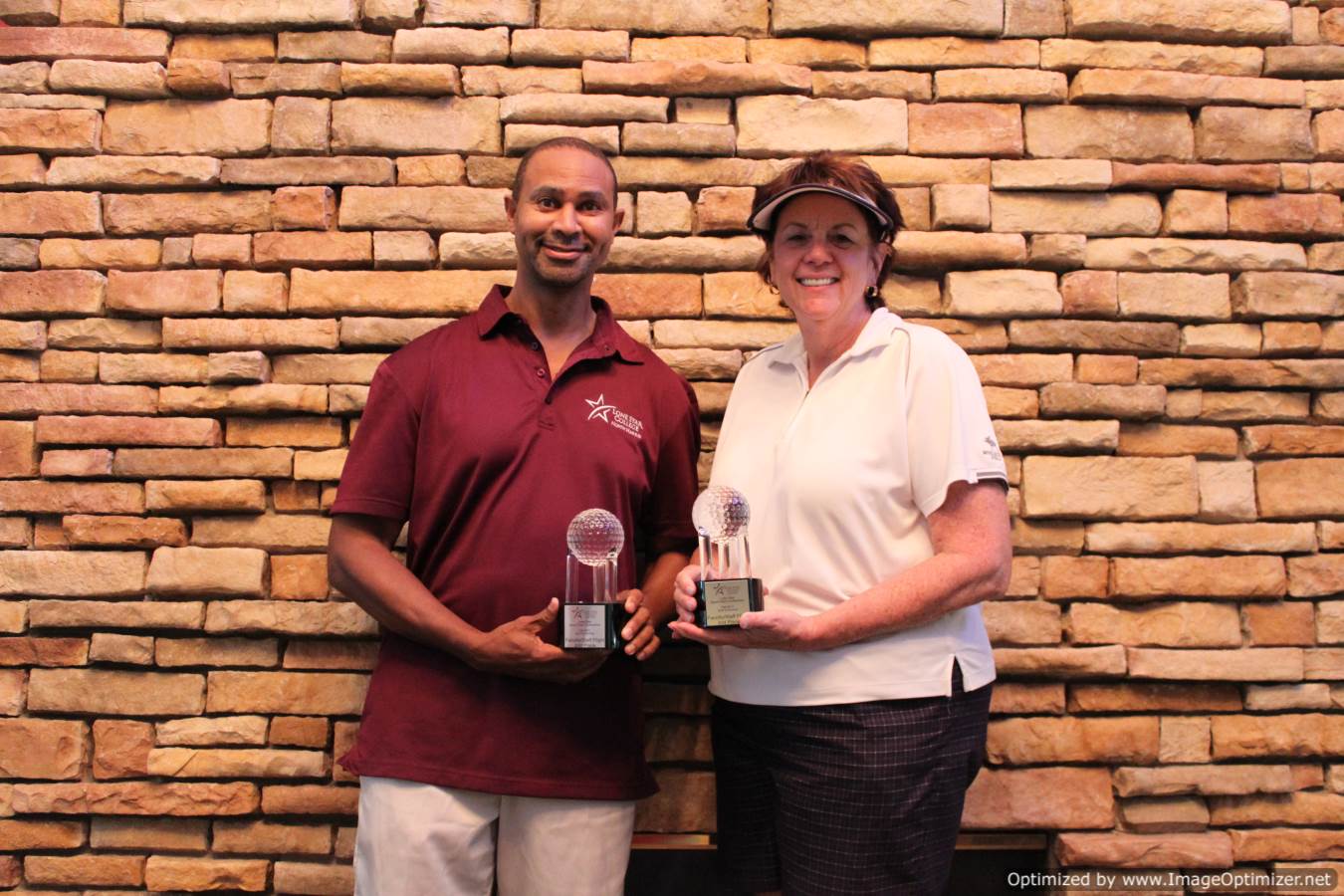 Photo of LSC employees holding a trophy