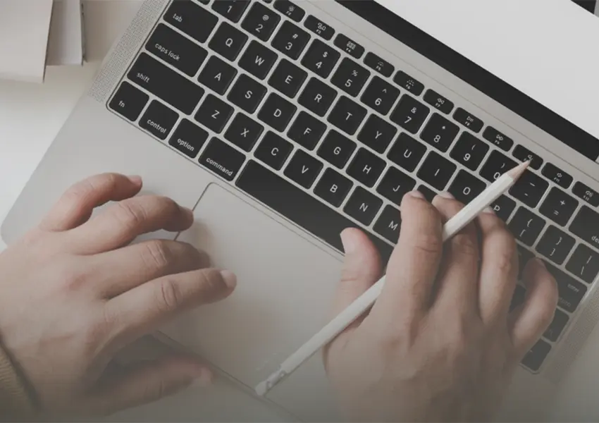 Person typing on a laptop