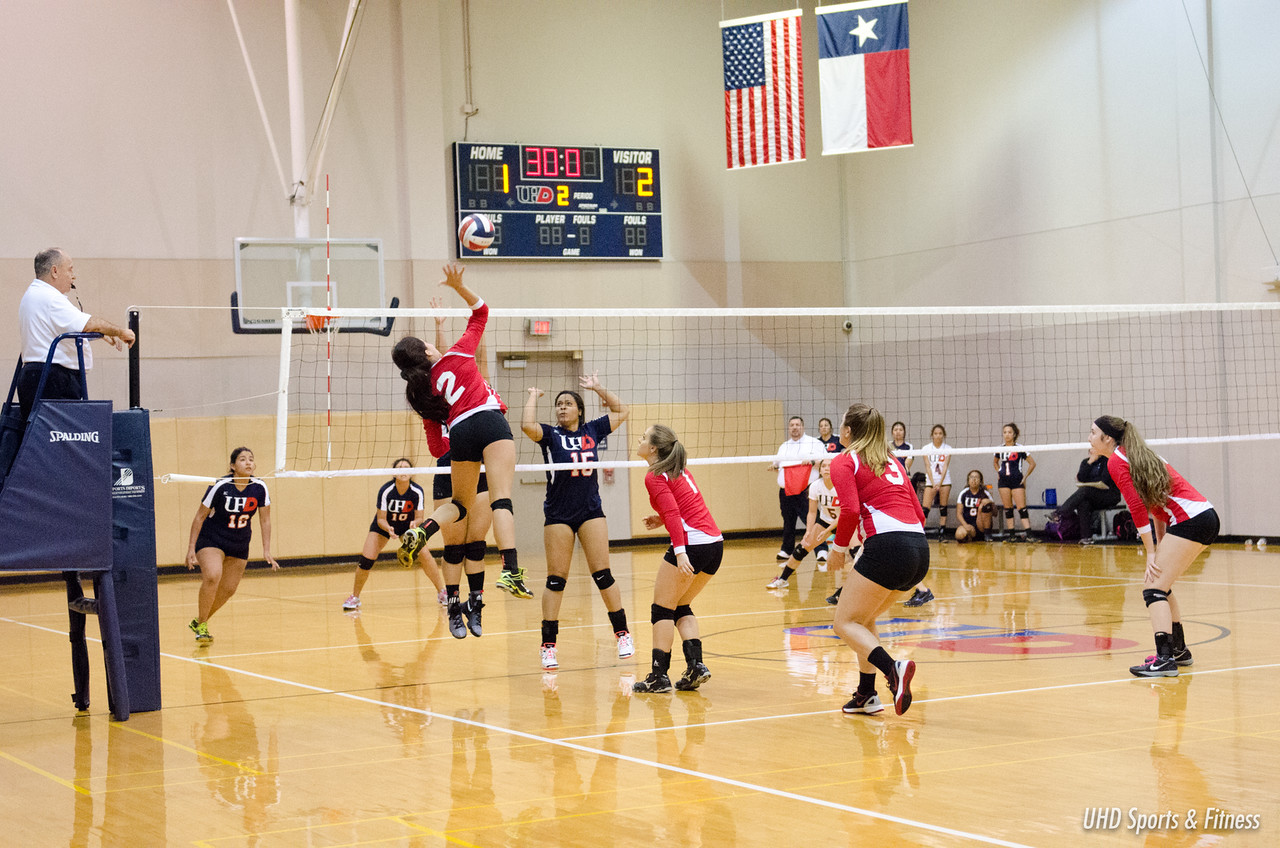 Photo of students from two different teams playing volleyball