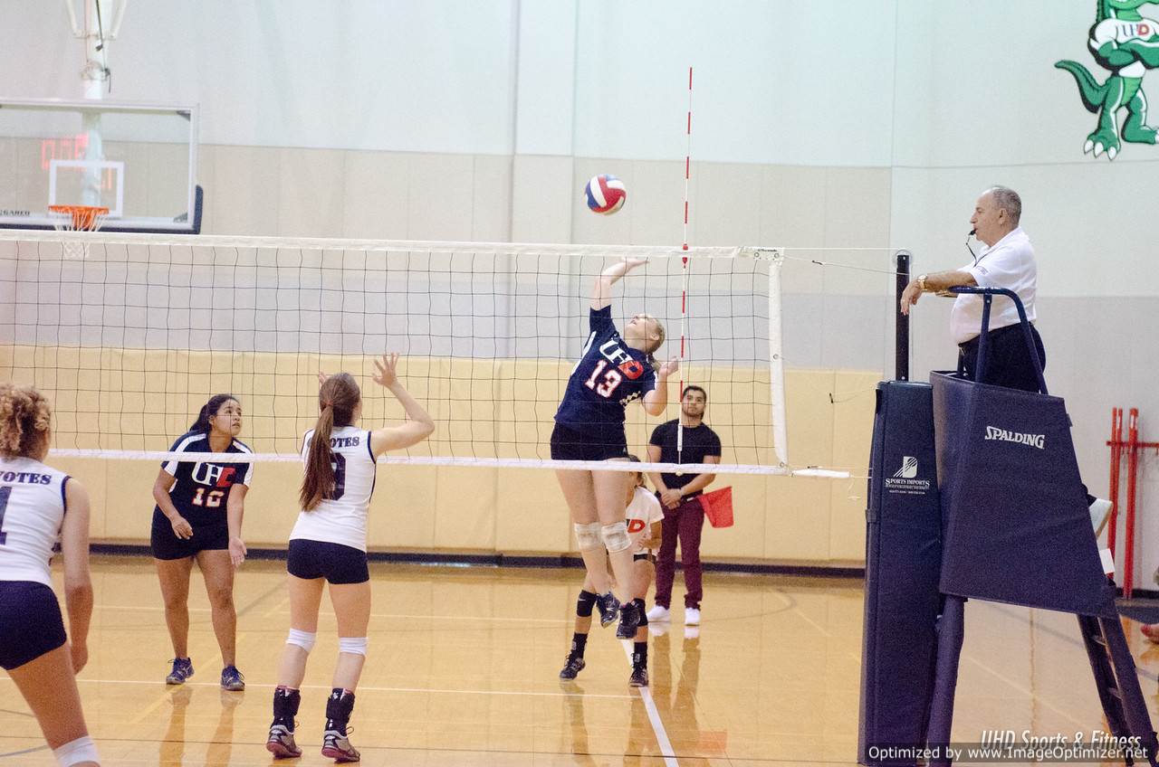 Photo of students from two different teams playing volleyball