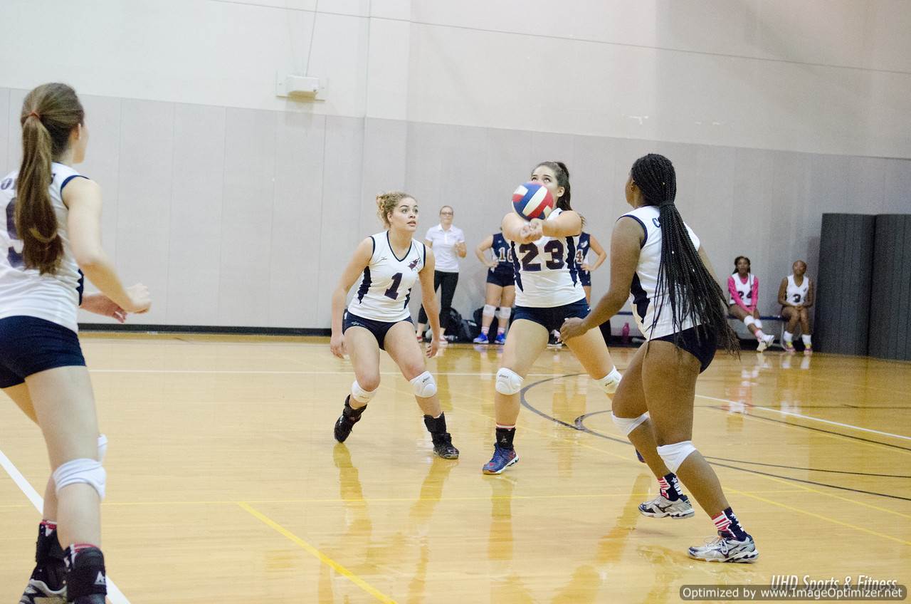 Photo of students from two different teams playing volleyball