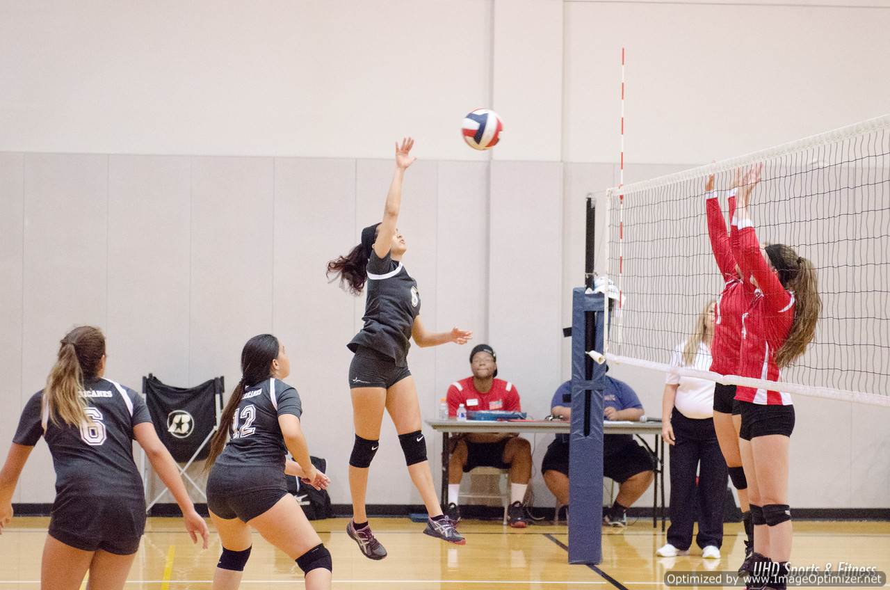 Photo of students from two different teams playing volleyball