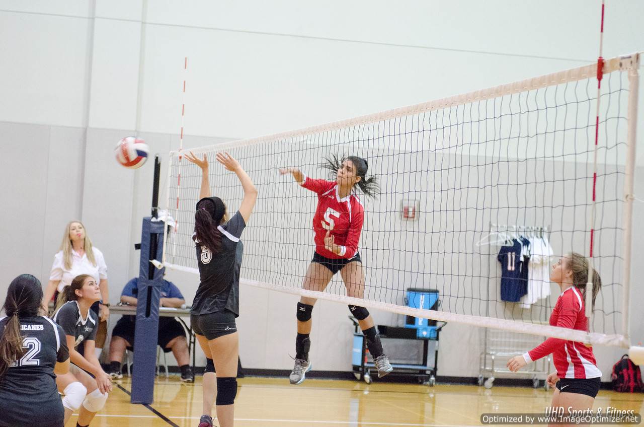 Photo of students from two different teams playing volleyball