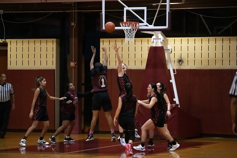 Women's Basketball Players Scoring a Basket