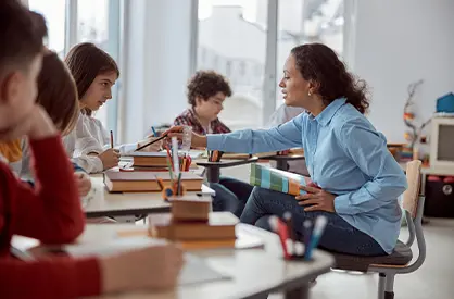 Teacher holding a tablet in front of students
