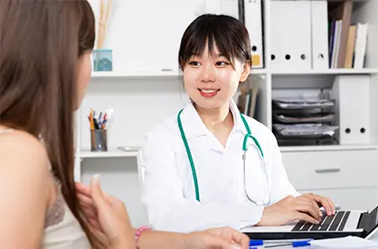 Medical assistant working on a laptop