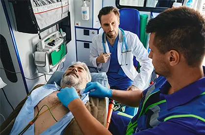 Paramedic attaching ekg nodes to a patient