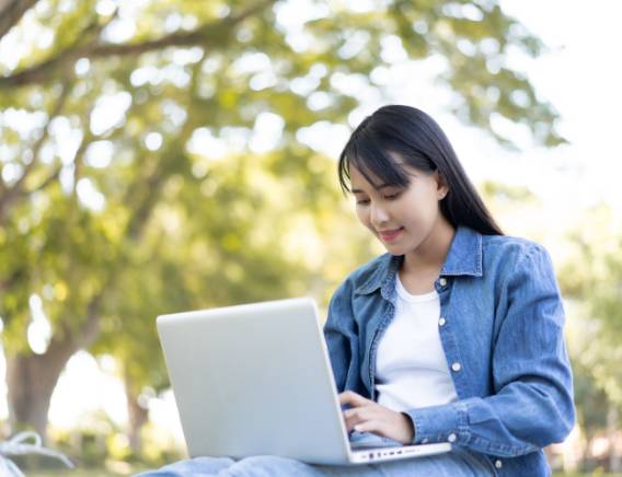 Young girl on her laptop outside