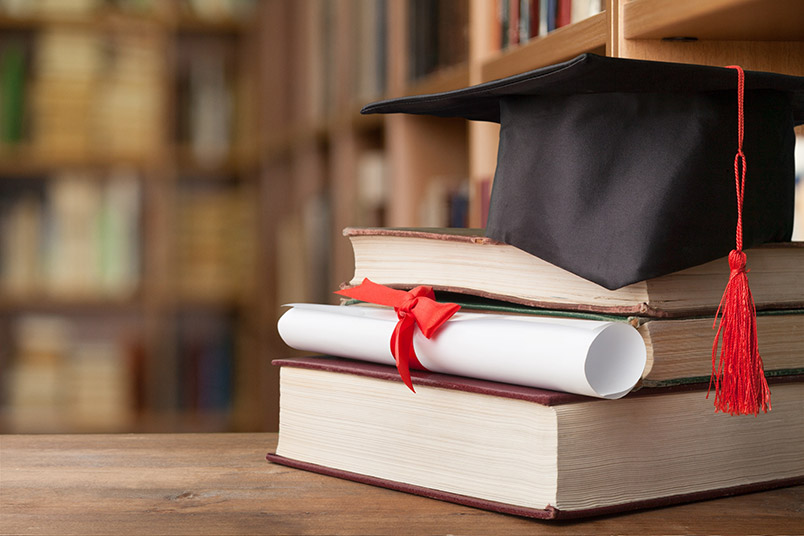 Graduation cap on top of books